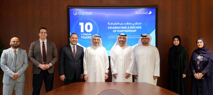 Top executives and officials from Al Ansari Exchange, Al Ansari Financial Services and Dubai Municipality gather to celebrate a decade of partnership between the two organisations